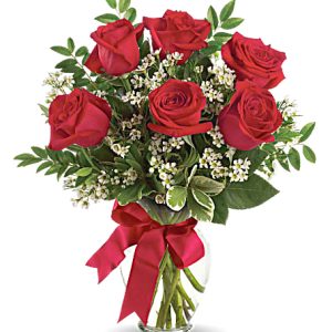 Six beautiful roses designed with fresh greenery and tasteful accents. Just perfect! Designed and delivered in a quality glass vase