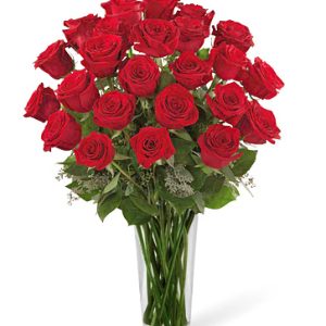 Send a message of lasting love from one heart to another with two dozen gorgeous premium red roses designed with fresh foliage and delivered in a tasteful glass vase. Exceptional! Florist delivery in the USA and Canada.