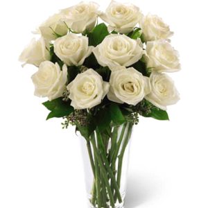 One dozen beautiful long-stem white roses tastefully arranged with fresh foliage in a quality glass vase. Simply elegant! Florist delivery in the USA and Canada.