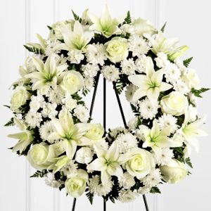 Send your deepest sympathy with this beautiful tribute featuring elegant white lilies