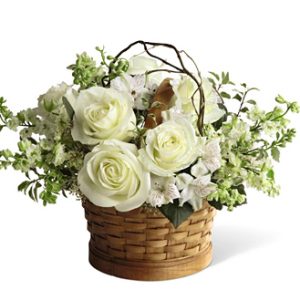 Send warmth and comfort with this compact basket bouquet of lovely white roses