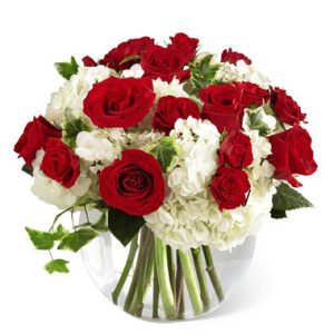 A stylish compact bouquet in dramatic reds and whites to convey your love