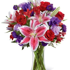 A stunning vased bouquet in regal red and purple hues with velvety roses