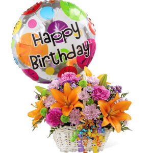 Make any birthday more special with this colorful surprise of seasonal fresh flowers designed in a basket and trimmed with a festive birthday mylar balloon. Featured blooms include lilies