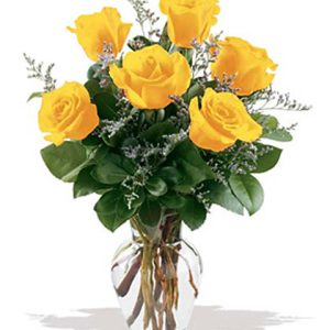 One half dozen cheery yellow roses vased with greens and accents. Great for birthdays