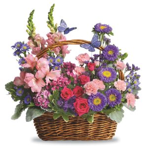 This charming basket bouquet features seasonal fresh flowers