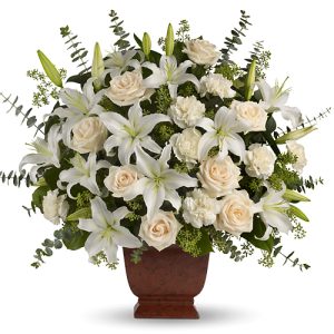 Embrace them in your thoughts and prayers with this elegant tribute of creme roses
