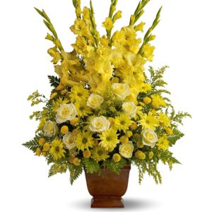 Express your sympathy with this striking funeral flowers tribute in sunlit yellow hues. Featured flowers include roses