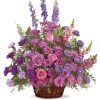 This lovely sympathy flowers basket features a soothing combination of seasonal fresh flowers