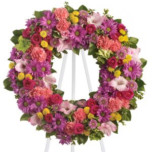Express your deepest compassion and caring with this dazzling multi-colored floral wreath featuring a rich variety of garden-fresh flowers