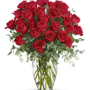Send a message deep from your heart with this stunning display of beautiful roses designed with seeded eucalyptus or similar accents in an elegant clear glass vase. This outstanding expression includes approximately thirty premium roses to value. An exceptional tribute of unending love