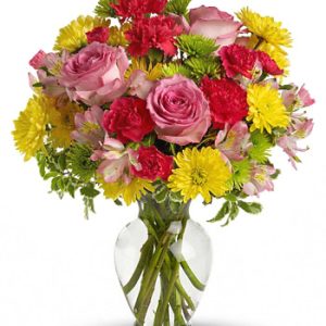 Brighten someone's day with this popular bouquet of colorful fresh flowers designed in a tasteful glass vase. Featured blooms include roses