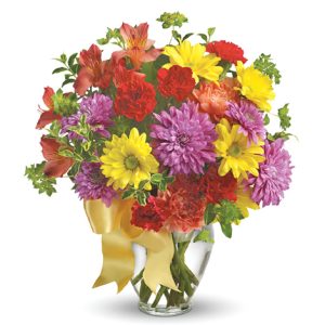 Catch someone's eye with this colorful combination of fresh seasonal blooms in red