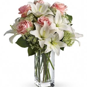 Lovely white lilies combined with soft pink roses