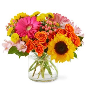 Make any day like a day at the beach with this sunny collection of colorful fresh blooms designed and delivered in a clear glass vase or cylinder. This popular compact design features sunflowers