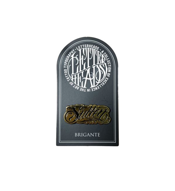 Grab this gold collectable Letterheads Pin with lettering by artist Brigante!     LETTERHEADS #4 - Brigante Tattoo -  @brigantetattoo