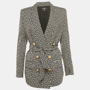 Balmain crafts a statement blazer in black and white monogram cupro. Double breasted with structured shoulders and gold tone buttons