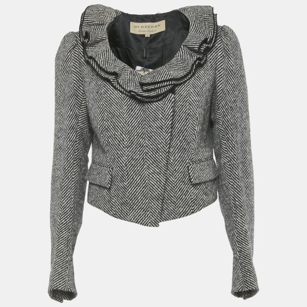 Classic Burberry herringbone is reinterpreted with ruffled trims along the neckline and scalloped edging along the back hem. The tailored fit keeps the jacket timeless.