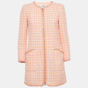 Chanel’s pink tweed fantasy jacket embodies the maison’s iconic textile reinterpreted with a playful hue. Structured seams and signature trim nod to the house’s couture heritage. Throw it over denim for modern contrast or wear with a matching skirt for full Parisian polish.