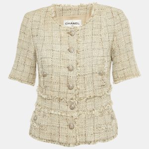 Chanel elevates classic tweed with lamé threads in this beige jacket
