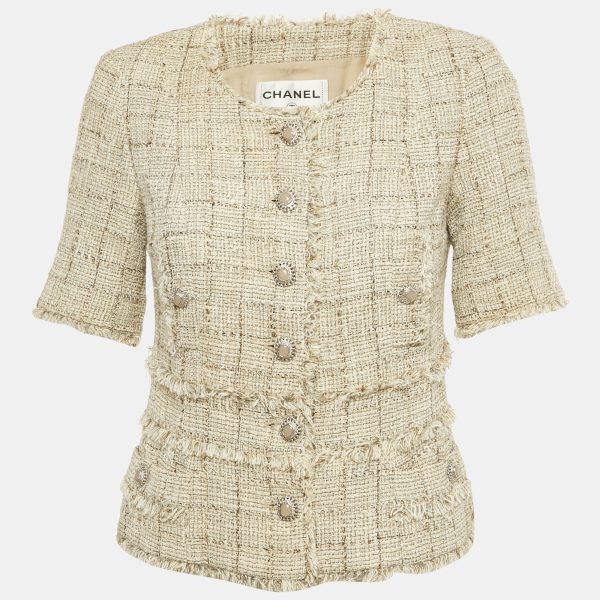 Chanel elevates classic tweed with lamé threads in this beige jacket