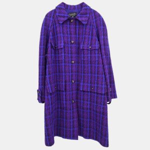 This Chanel coat channels the confident minimalism of the era with a palette rich in royal intent. The tailored structure is softened by its lush