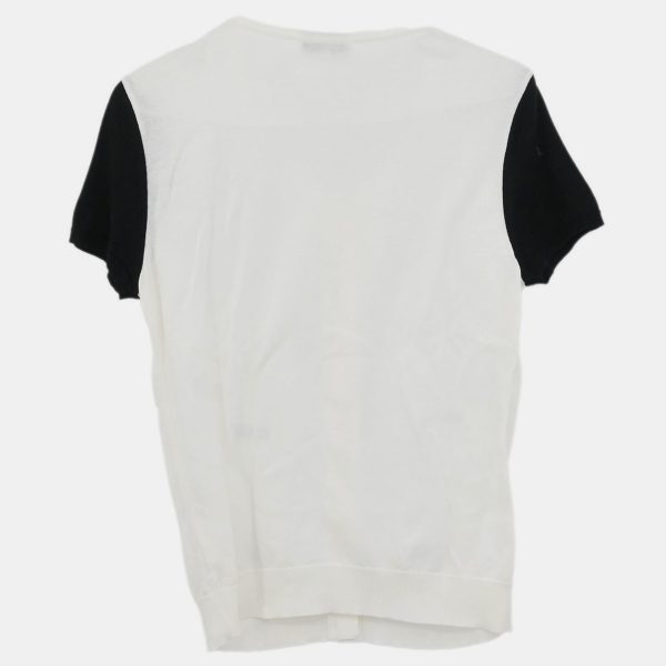 this Chanel cardigan offers a softened take on structure. The short sleeves and crisp white hue make it an effortless layering piece — polished