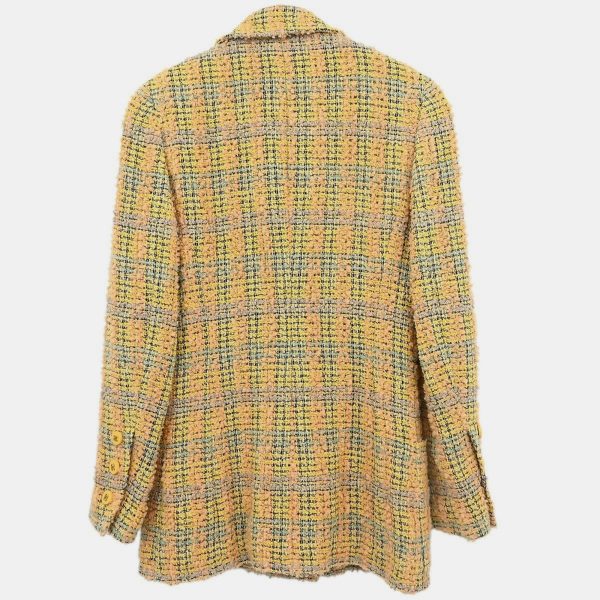 this yellow tweed jacket channels the effervescence of Chanel’s golden years under Karl Lagerfeld. The double breasted cut is tailored yet buoyant — a sunlit take on structured sophistication. A rare vintage vision
