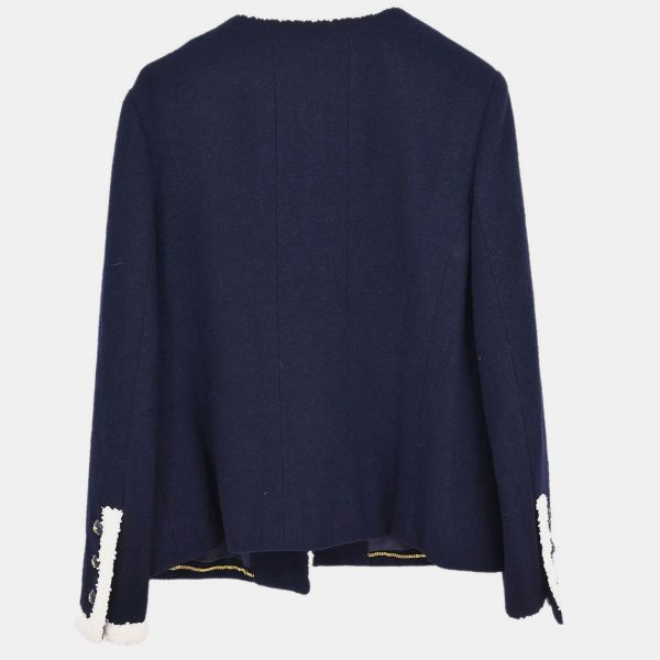 this navy Chanel jacket opts for quiet authority over embellishment. The collarless silhouette invites modern interpretation