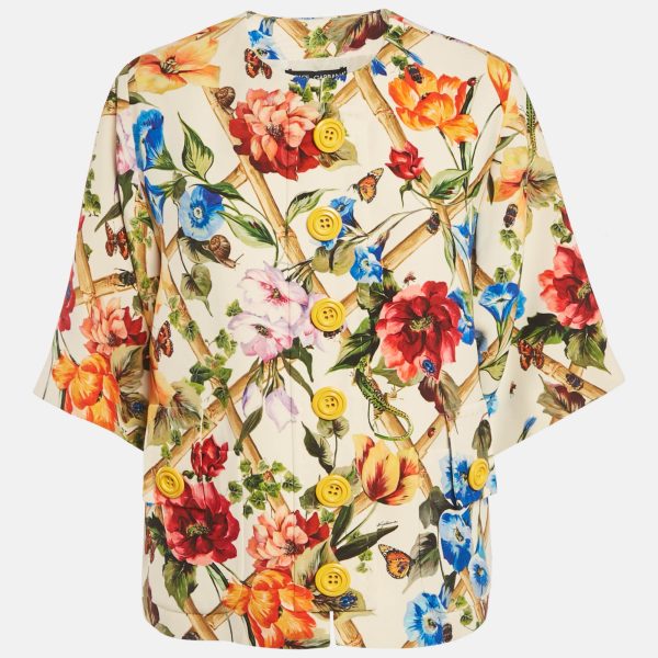 Dolce and Gabbana brings elegance to outerwear with this cream crepe jacket adorned with floral prints. The button front design adds polish
