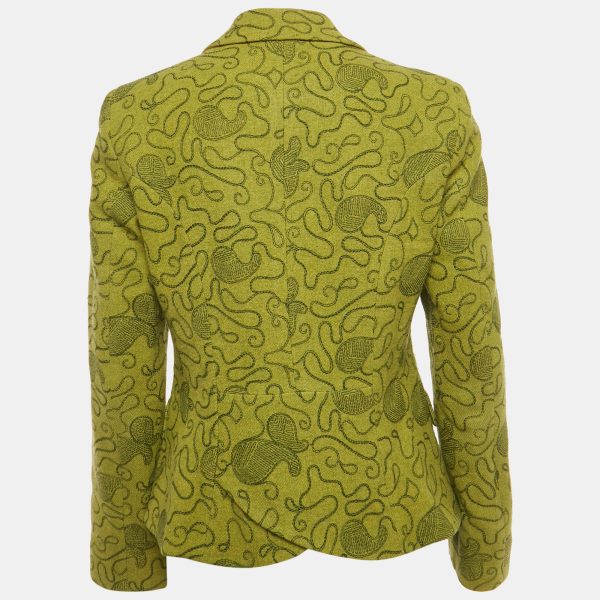 bringing a dash of its bohemian Milanese spirit into tailoring. The structured shoulders and slim cut contrast with the ornate stitching for a balanced look. Layer it over a silk blouse or turtleneck for a polished yet eclectic statement.