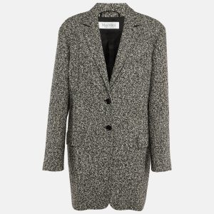 Max Mara’s Ovale blazer embodies the house’s architectural tailoring in classic black and white tweed. The oversized cut offers relaxed structure