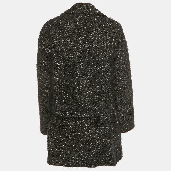 giving movement to a fabric often considered still. The double breasted cut lends structure to its long frame