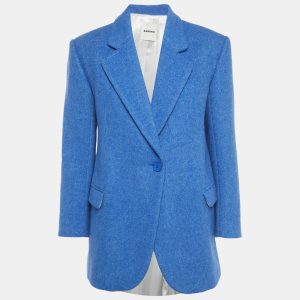 Sandro reimagines the tailored jacket in a blue wool blend with an oversized fit. The relaxed shoulders and precise lapels speak to the brand’s mix of structure and ease. Throw it over dresses or denim for instant polish.