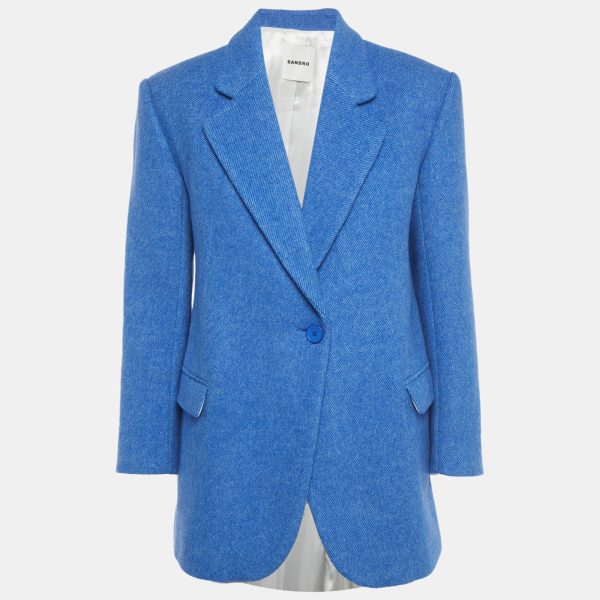 Sandro reimagines the tailored jacket in a blue wool blend with an oversized fit. The relaxed shoulders and precise lapels speak to the brand’s mix of structure and ease. Throw it over dresses or denim for instant polish.
