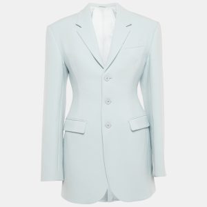 Wardrobe NYC offers a modern uniform with this blue wool crepe blazer. The button front closure and clean lines embody quiet sophistication. It’s a perfect anchor piece for sharp trousers or layered over a slip dress.