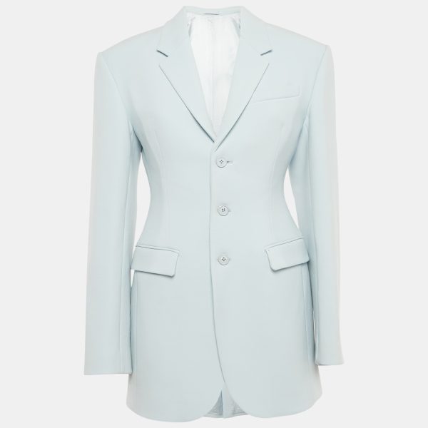 Wardrobe NYC offers a modern uniform with this blue wool crepe blazer. The button front closure and clean lines embody quiet sophistication. It’s a perfect anchor piece for sharp trousers or layered over a slip dress.