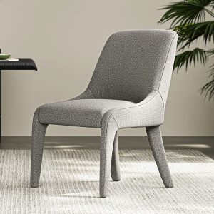 Meet Benton. This dining chair features a beautifully intertwined design with soft curves and subtle splayed legs.The architectural frame is fully upholstered in soft